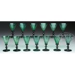 SET OF 13 EARLY BLOWN GREEN WINES. This set in beautiful emerald green with faceted paneled sides