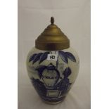 DELFT, a wet drug delft jar inscribed "Violet" decorated with Indian (restored) and brass cover, 15"