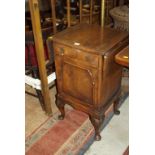 BEDSIDE CABINET, cross banded walnut bedside cabinet on shell carved cabriole legs