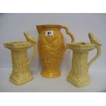 WADE, orange glazed floral sculptured Art Deco jug and pair of similar bird bath jugs