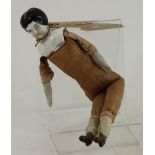 A miniature Victorian doll with ceramic head composition arms and legs and fabric body