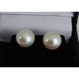 A pair of silver pearl earrings