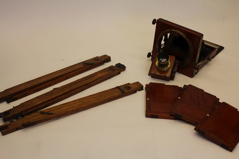 An early 20th century Half Plate 'Triple Victo' mahogany and brass field camera with black leather