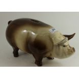 A large pottery money box in the form of a pig