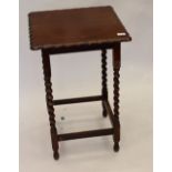 A Victorian oak side table on barley twist suports
