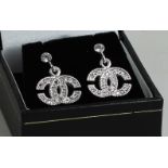 A pair of Channel style silver and CZ earrings