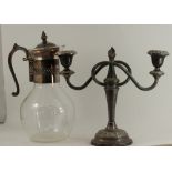 A mixed collection of silver plate including a condiment set, tea set, serving dishes, candle stick,
