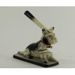 A painted cast metal table top hole punch in the form of a dog