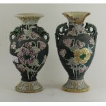 A pair of chinese twin handled pottery vases with floral enamel decoration, character marks to base.