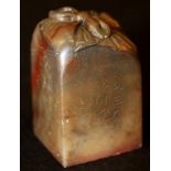 A CHINESE SOAPSTONE SEAL, the side with two columns of calligraphy, the top carved with a tied knot,