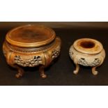 TWO SIMILAR EARLY 20TH CENTURY CHINESE CARVED HARDWOOD VASE STANDS, each supported on scroll feet,