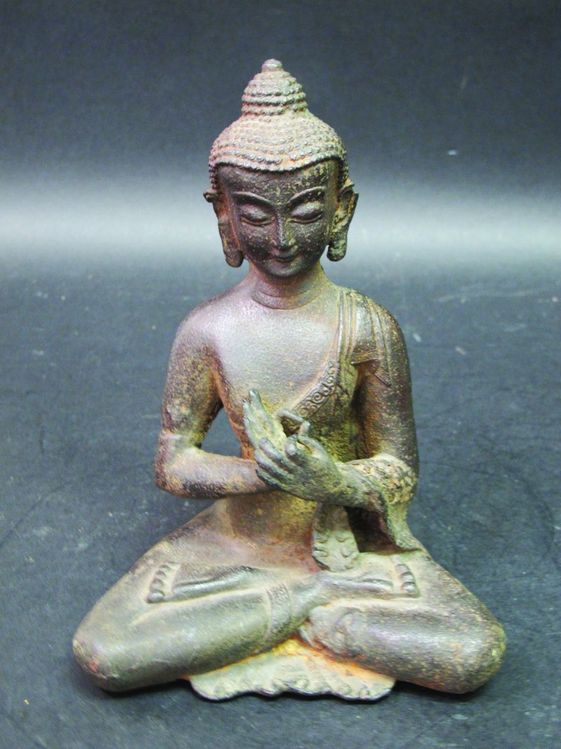 A CHINESE MING DYNASTY CAST IRON FIGURE OF BUDDHA, 16th Century, seated in meditation, the hems of