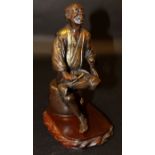 A GOOD JAPANESE MEIJI PERIOD PARCEL GILT BRONZE MODEL OF A MAN SEATED ON A BARREL, together with a