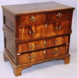 AN EARLY 18TH CENTURY OAK AND WALNUT STRAIGHT FRONT CHEST in two parts, plank top over two short and