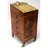 A REGENCY MAHOGANY AND EBONY INLAID DAVENPORT of small size, with brass gallery, leather inset