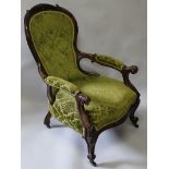 A GOOD VICTORIAN MAHOGANY SPOON BACK ARMCHAIR with carved show wood frame, on cabriole legs with