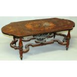 A FRENCH MAHOGANY AND ORMOLU MOUNTED LOW TABLE of serpentine outline, the top inlaid with floral