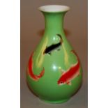 A 20TH CENTURY ORIENTAL PORCELAIN VASE, decorated with carp swimming against a lime-green ground,