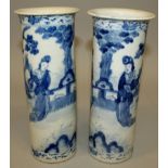 A PAIR OF 19TH CENTURY CHINESE BLUE & WHITE PORCELAIN SLEEVE VASES, painted with ladies in garden