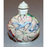A 20TH CENTURY CHINESE MOULDED PORCELAIN SNUFF BOTTLE & STOPPER, the sides decorated with