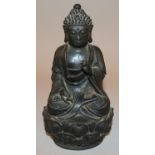 A CHINESE BRONZE FIGURE OF BUDDHA, possibly 16th Century, seated with serene expression upon a