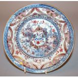 AN 18TH CENTURY CHINESE CLOBBERED PORCELAIN DISH, painted in underglaze-blue and in European iron-