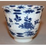 A GOOD CHINESE KANGXI PERIOD BLUE & WHITE PORCELAIN BEAKER CUP, circa 1700, the cell-moulded sides