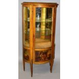 A FRENCH GILT WOOD VITRINE of serpentine outline, the single glazed door enclosing two glass shelves