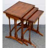 A REGENCY STYLE NEST OF THREE MAHOGANY TABLES.Largest 1ft 7ins wide x 1ft 1.5ins deep x 1ft 10.
