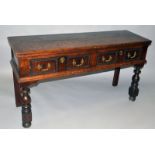 A SMALL 18TH CENTURY OAK DRESSER BASE with two plank top, two small drawers with brass handles and