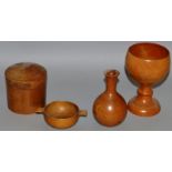A TREEN CHALICE, circular box and cover, small Quaich and small vase (4).