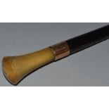 AN EBONY CANE with horn handle. 36ins long.
