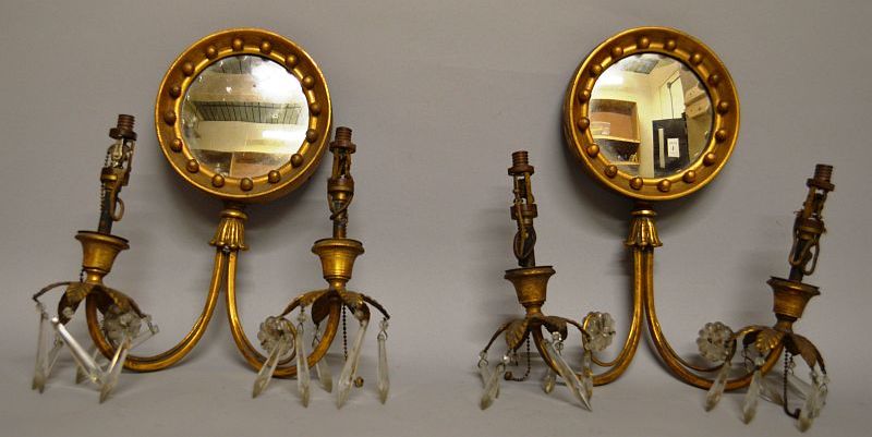 A SUPERB SMALL PAIR OF REGENCY TWO BRANCH WALL SCONCES with circular mirrored back, curving arms and