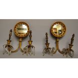 A SUPERB SMALL PAIR OF REGENCY TWO BRANCH WALL SCONCES with circular mirrored back, curving arms and