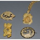 A CARVED IVORY CHAIN AND ROSE PENDANT AND THREE BROOCHES.