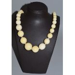 AN IVORY FIFTY BEAD NECKLACE,