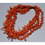 A FIVE STRAND CORAL NECKLACE.