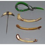 A SNAKE BROOCH AND FOUR BONE PINS.