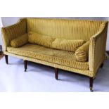 A GEORGE III MAHOGANY FRAMED “CAMPAIGN” SETTEE with removable high back and arms, upholstered with