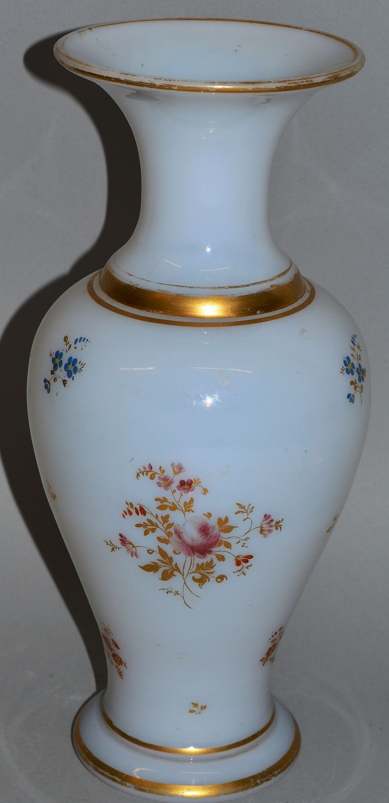 A 19TH CENTURY OPALINE GLASS VASE painted with flowers and gilded. 11.5ins high.