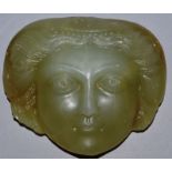 AN UNUSUAL MOULDED GLASS FRAGMENTARY FACE OF A WOMAN. 5ins wide.