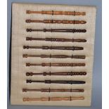 A COLLECTION OF ELEVEN TURNED WOOD LACE BOBBINS, all various different woods.