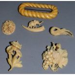 AN IVORY BUCKLE AND FIVE CARVED BROOCHES.