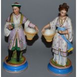 A PAIR OF 19TH CENTURY BISQUE CHINESE FIGURES OF A MAN AND WOMAN on circular bases. 8ins high.