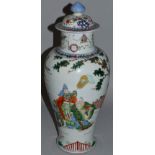 A CHINESE FAMILLE ROSE VASE AND COVER decorated with figures etc. Kang Hsi mark in blue. 17ins