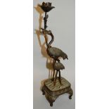 A JAPANESE BRONZE GROUP OF TWO STORKS on a stand. 13ins high.