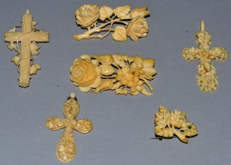 THREE CARVED IVORY BROOCHES AND THREE CROSSES.