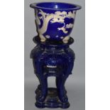 A LARGE MINTON BLUE AND WHITE JARDINIERE ON STAND decorated with birds in relief. 3ft 8ins high.