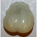 A CHINESE CELADON-GREEN JADE-LIKE MODEL OF FRUIT, 1.5in high.