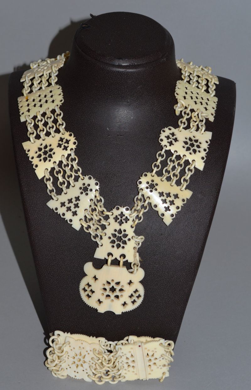 A CARVED AND PIERCED IVORY NECKLACE AND BRACELET.